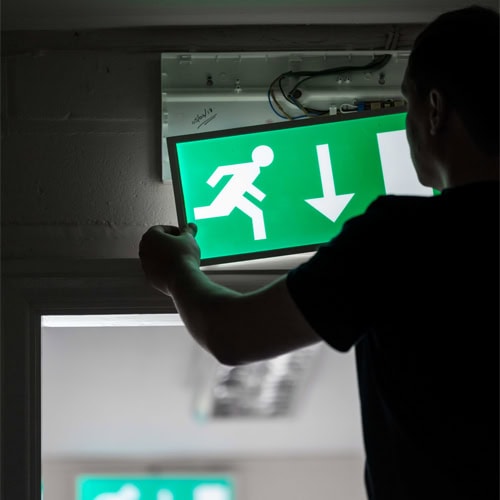 Technician performing Emergency Light Testing Melbourne